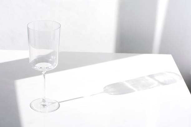 istock empty transparent wine glass and reflection on white background 1305171826