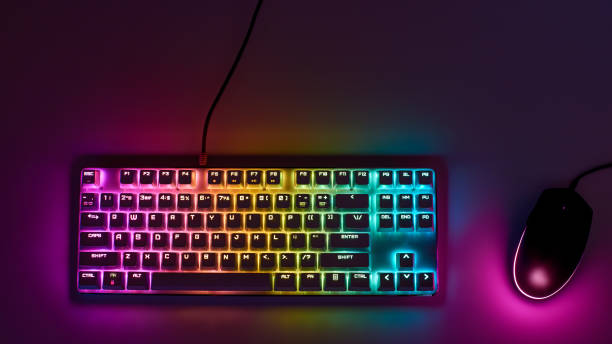istock Gaming keyboard with RGB light. White mechanical keyboard and mouse with backlight. Colorful keyboard and mouse with RGB backlight. Gamer's Workspace 1305173885