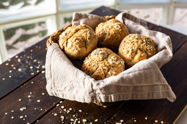 istock Delicous breakfast rolls in a bread basket on wooden plank 1305175015