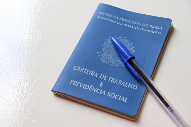 istock Brazilian work card (carteira de trabalho) and blue pen. 1305176345