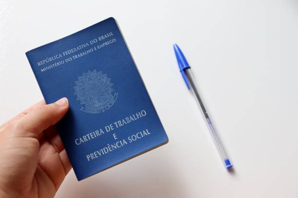 istock Woman holding Brazilian work card (work card). 1305176352