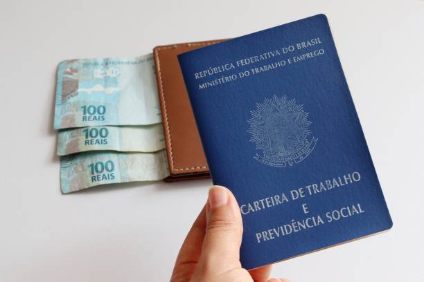 Hand holding brazil's work card, with money wallet in the fund. Real notes from Brazil. Concept of formal employment. wallet photos stock pictures, royalty-free photos & images