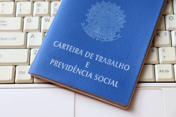 istock Brazilian work card (carteira de trabalho) on top of laptop. Digital work concept. 1305176459