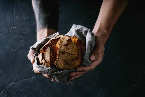 Traditional Portuguese bread Broa de milho in male hands stock photo