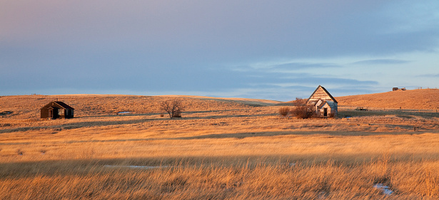 A wide panorama of an old ghost town with white church on the great plains. Image taken in rural Saskatchewan, Canada.