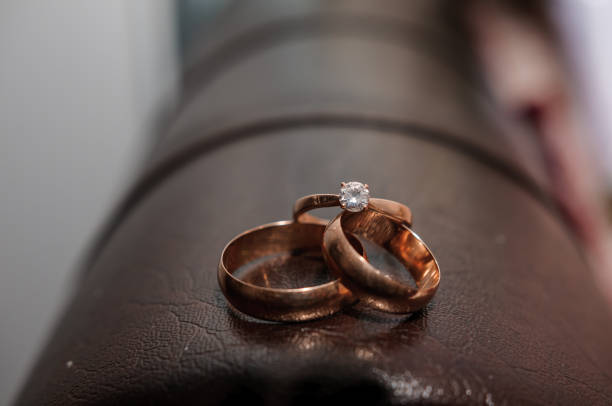 istock Wedding gold rings on brown background 1305182010