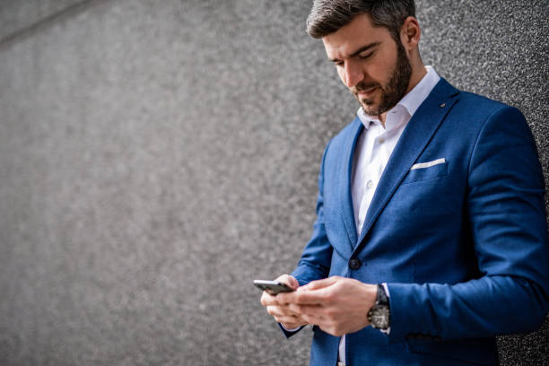 istock Mid adult businessman using phone. 1305184165