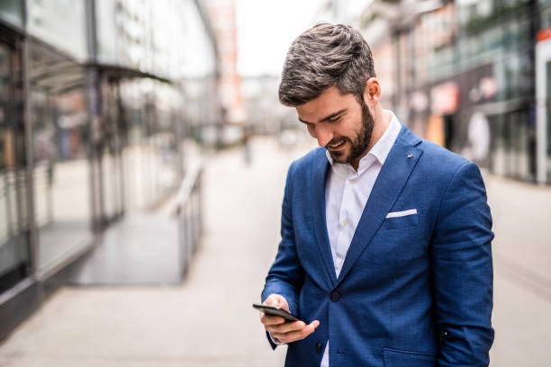 istock Happy mid adult businessman using phone. 1305185556