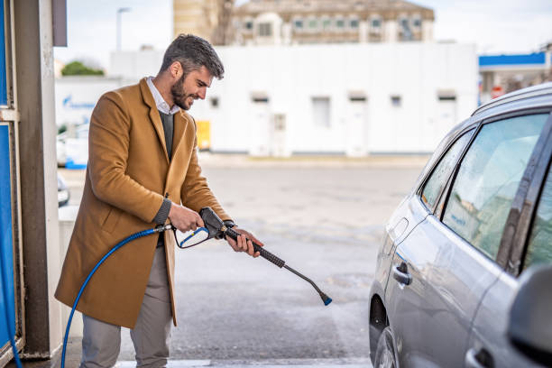 istock Happy man washing his car. 1305185703