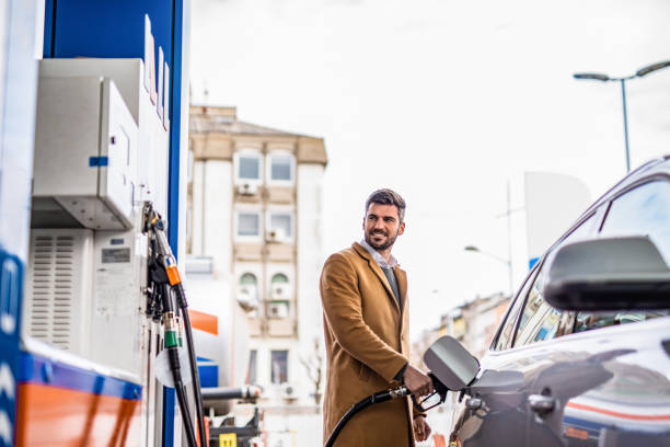 istock Happy man at the gas station. 1305185899