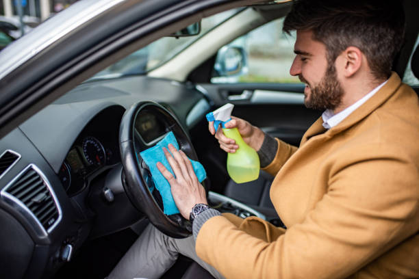 istock Happy man cleaning his car interior. 1305187546