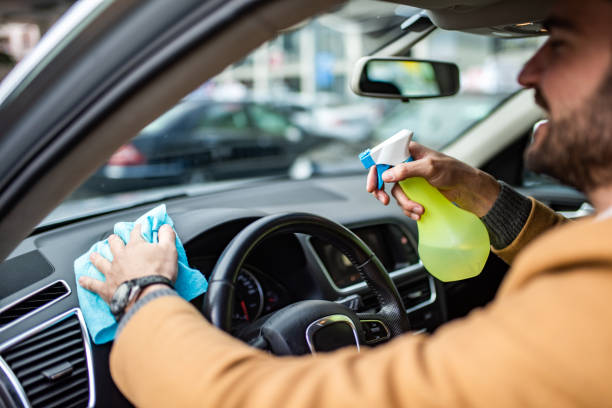istock Happy man cleaning his car interior. 1305187579