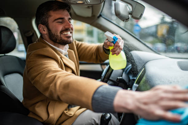 istock Happy man cleaning his car interior. 1305187727