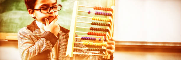 istock Pupil dressed up as teacher holding abacus 1305187944