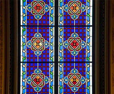 Victorian stained glass set in a window from the Decorated Period in the chancel of St Peter’s Church in Spixworth, near Norwich in Norfolk, Eastern England.