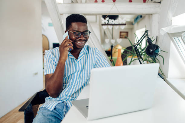 istock Young African-American working and making a call at his home office 1305188999