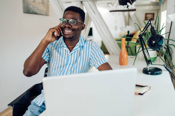 istock Young African-American having a call at his home office 1305189007