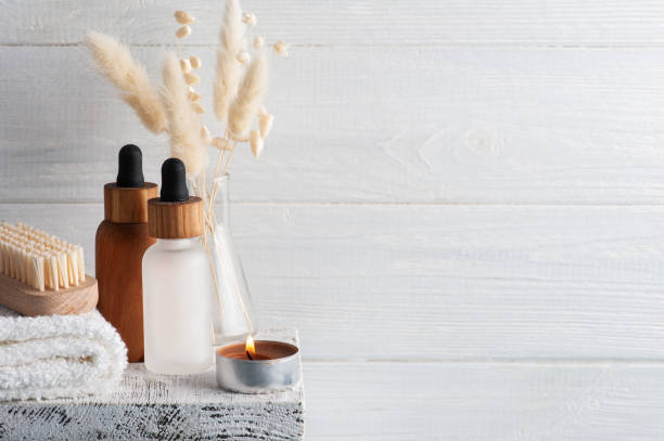istock Cosmetic essential oil on wooden background 1305189347