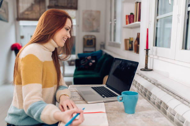 istock Young economist working at her home office 1305189803