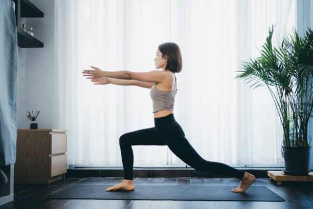 istock Woman practicing yoga at home 1305194844