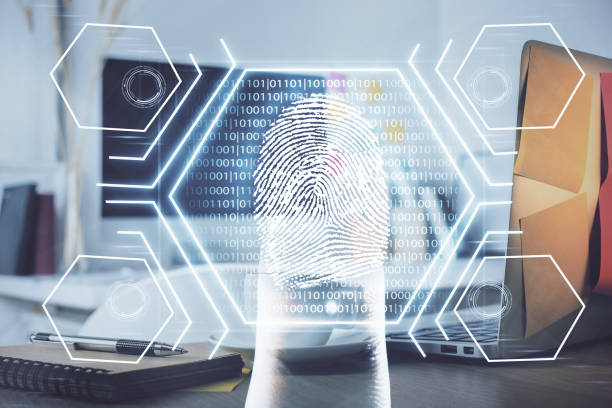 istock Computer on desktop in office with finger print drawing. Double exposure. Concept of business data security. 1305196019