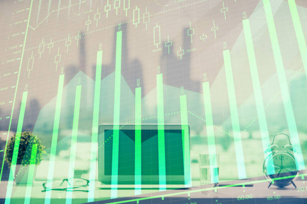 istock Forex graph hologram on table with computer background. Multi exposure. Concept of financial markets. 1305196092