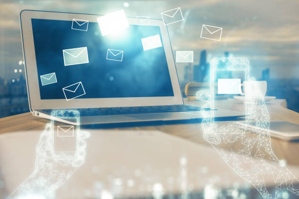 istock Desktop computer background in office and flying envelops hologram drawing. Multi exposure. Electronic mail concept. 1305196258