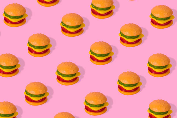 istock Creative trendy idea fast food pattern-  Hamburger on bright pink background 1305197234