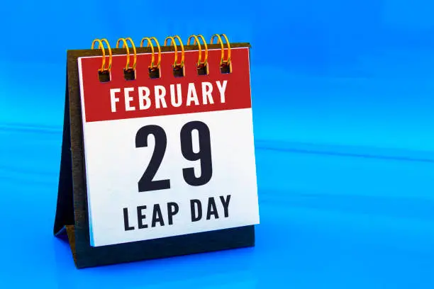 A calendar page on February 29 on a leap day on a blue background. Concept: Leap Year