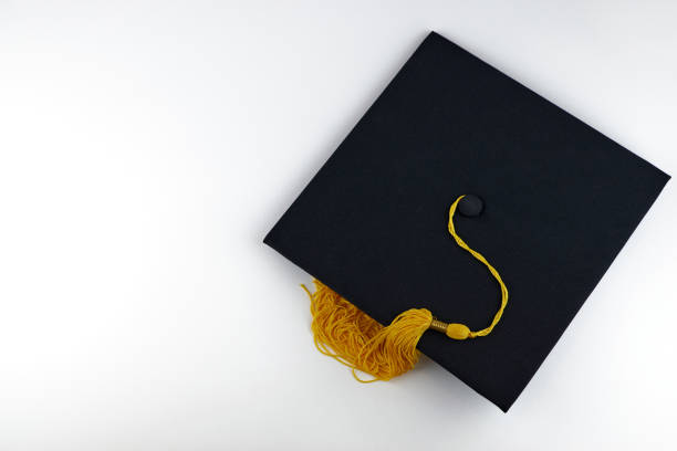 istock Black graduation cap on a white background, copy space. Academic hat, graduation concept 1305206979
