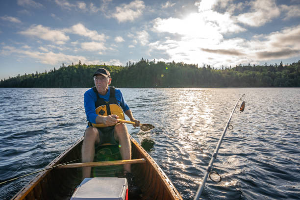istock Senior man fishing. 1305207363