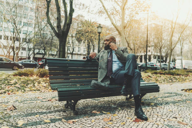 istock Black man entrepreneur phoning, park 1305210313