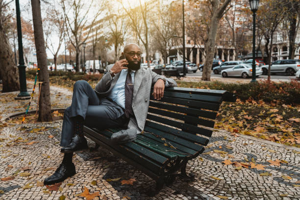 istock Black man entrepreneur phoning, park 1305210351