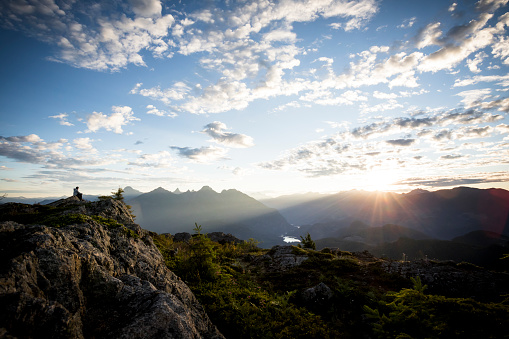 Male hiker looking at views from top of mountain. Sunshine Coast, BC, Canada. Sunshine Coast Trail.