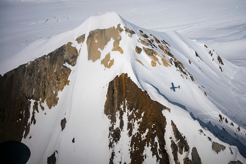 Aerial view at 38,000 feet of snow covered mountain tops around Birch County, Alberta, Canada at 55 41.1542N 118 32.675W