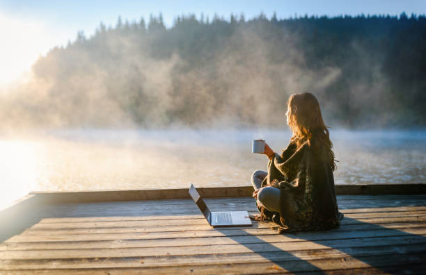 istock Woman Relaxing In Nature And Using Technology 1305213320