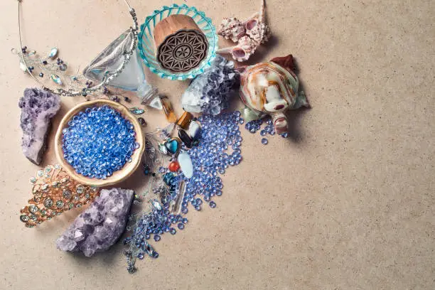 Beautiful stones, crystals, minerals, and other materials on a cardboard textured surface