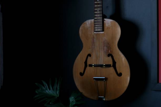 istock Old acoustic guitar hanging 1305221074