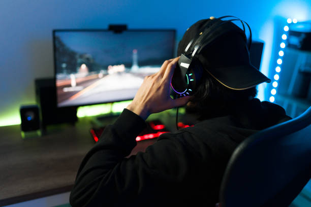 istock Young man playing a video game at his bedroom desk 1305225013