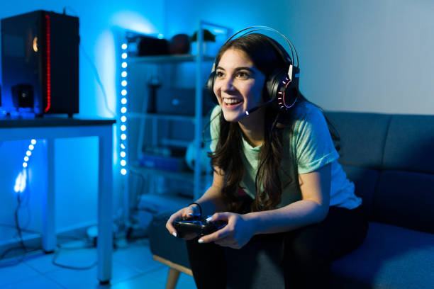 istock Woman gamer smiling while talking to an online player 1305225127