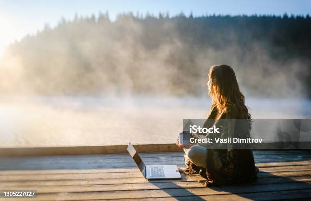 Woman Relaxing In Nature And Using Technology Stock Photo - Download Image Now - Telecommuting, Nature, Tranquility