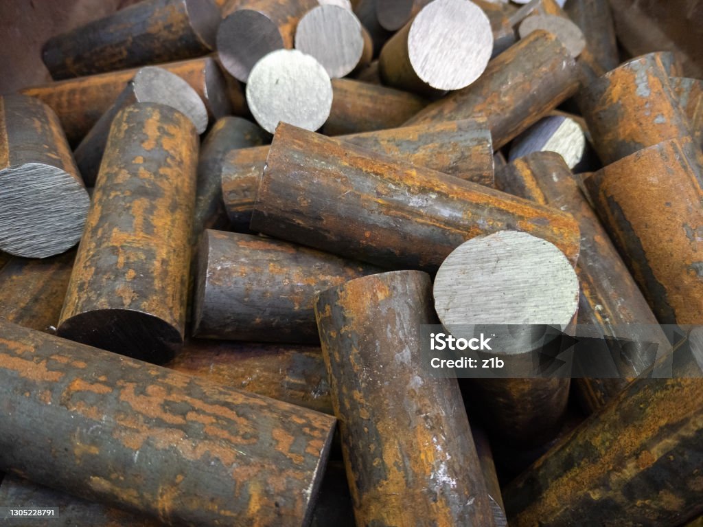 a pile of raw steel short rods cutted by saw- workpieces prepaired for forging, close-up with selective focus a pile of raw steel short bars cutted by saw- workpieces prepaired for forging, close-up with selective focus and background blur Blacksmith Shop Stock Photo