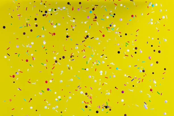 istock Abstract flying colorful pastry sprinkles on yellow background. 1305230171
