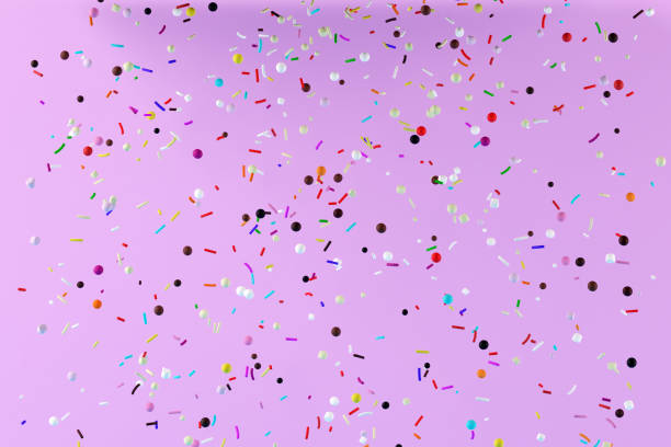 istock Abstract flying colorful pastry sprinkles on pink background. 1305230210