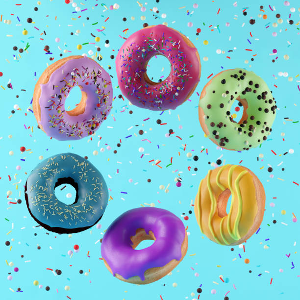 istock Colorful flying doughnuts with sprinkles on blue background. 1305230224