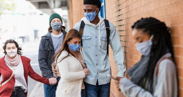 istock People walking on city sidewalk, wearing face masks 1305231736