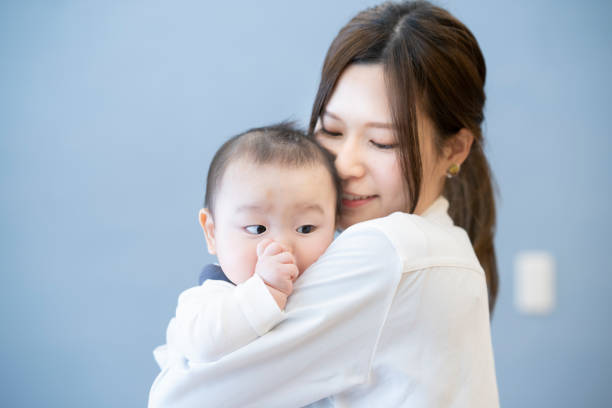 istock Young mom holding a baby 1305233329