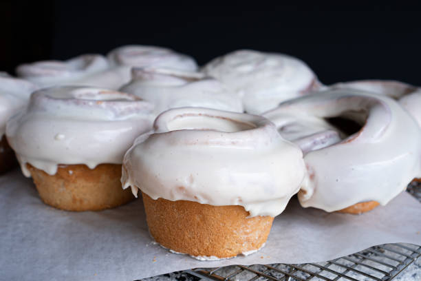 istock Exquisite homemade cinnamon rolls covered in white frosting. 1305233492