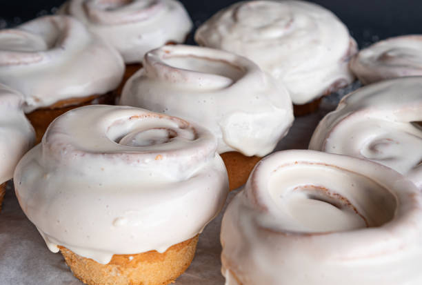istock Exquisite homemade cinnamon rolls covered in white frosting. 1305233544