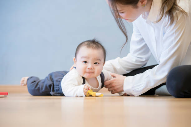 istock Mom playing with baby indoors 1305235445